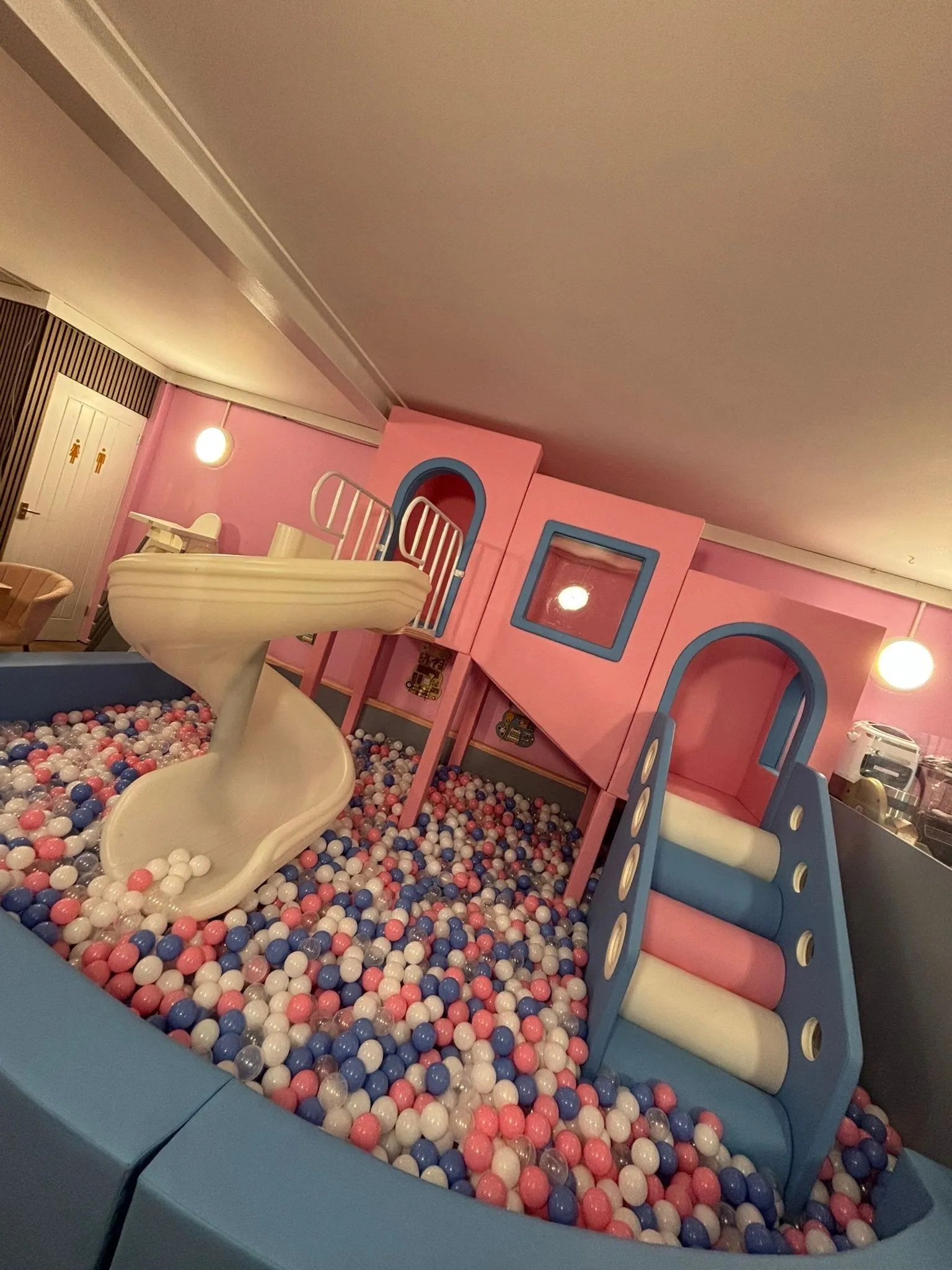 The ball pit and spiral slide under the play frame